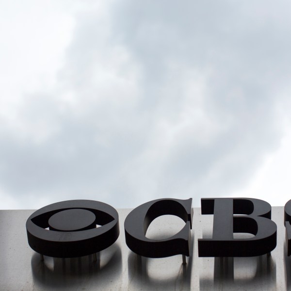 FILE - The CBS logo appears at their broadcast center in New York on May 10, 2017. CBS News has asked all of its local stations to become proficient in “solutions journalism,” a story-telling method that has taken off in the past decade to counter people who think reporters are obsessed with bad news.(AP Photo/Mary Altaffer, File)