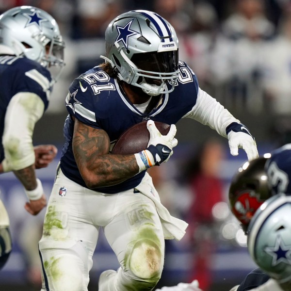 FILE - Dallas Cowboys running back Ezekiel Elliott (21) looks for running room as he rushes with the ball during an NFL wild-card football game against the Tampa Bay Buccaneers, Jan. 16, 2023, in Tampa, Fla. A person familiar with the terms tells The Associated Press that three-time Pro Bowl running back Elliott has signed a one-year deal with the New England Patriots worth $4 million. The person spoke on condition of anonymity because the team has not announced the move. (AP Photo/Peter Joneleit, File)